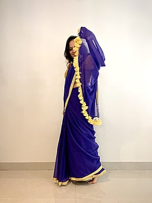PURPLE MUL COTTON PLAIN SAREE WITH YELLOW INCH BORDER AND POMPOMS ON PALLU PURPLE MUL COTTON PLAIN SAREE WITH YELLOW INCH BORDER AND POMPOMS ON PALLU
